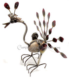 METAL PEACOCK WITH ROCK rocks with wind